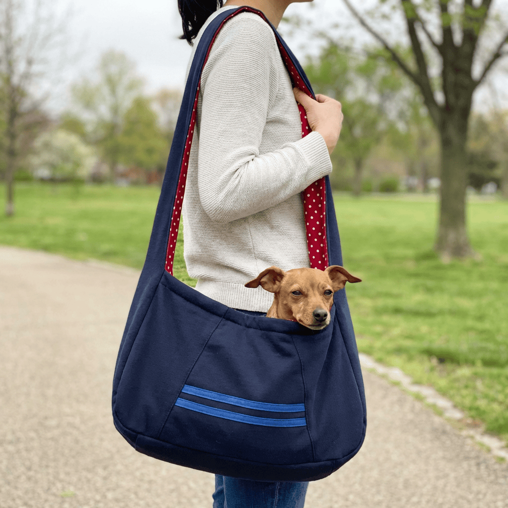 Woman carrying an Adjustable Outdoor Pet Carrier with a small dog inside, featuring a lightweight design and adjustable strap.