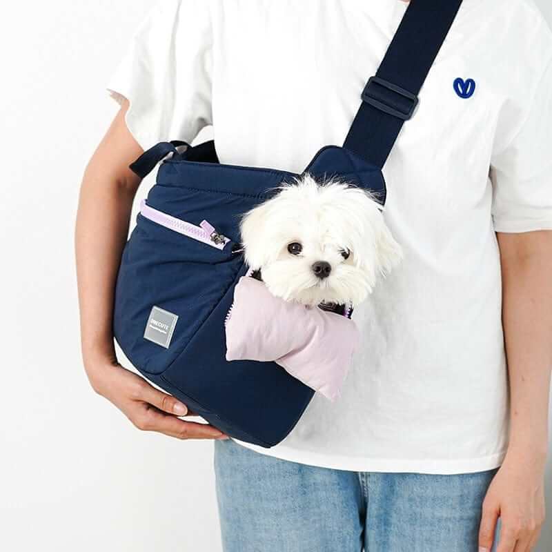 BreezeVent Pet Travel Bag featuring a small dog comfortably carried in a stylish crossbody design with breathable mesh.