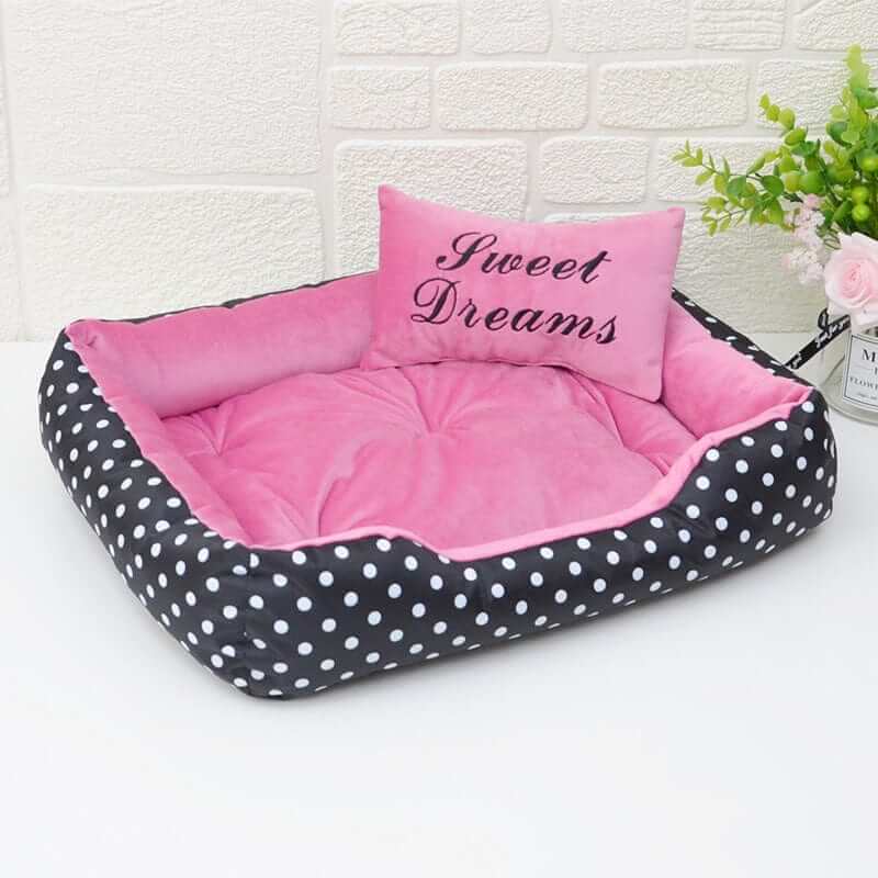 ComfortNest Dog Bed featuring pink plush interior with polka dot design and 'Sweet Dreams' cushion for dogs and cats.
