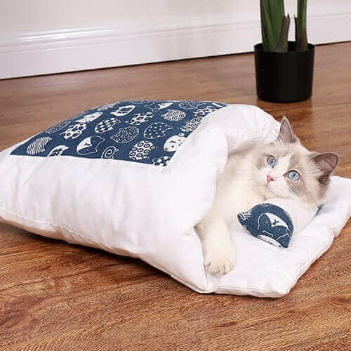 CozyNest Washable Cat Bed with a cat snuggled inside, featuring a soft, plush design and cozy cave-like environment.