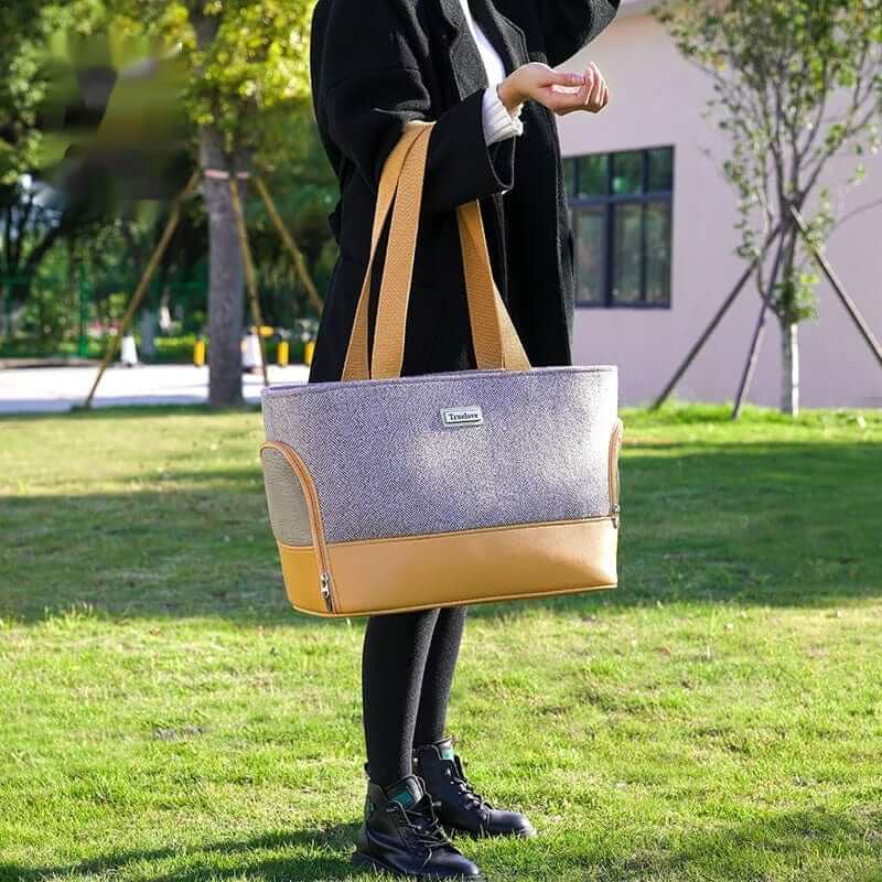 Fashionable Wool Pet Travel Carrier Bag held by a person outdoors, features durable wool fabric and a chic design for pets.