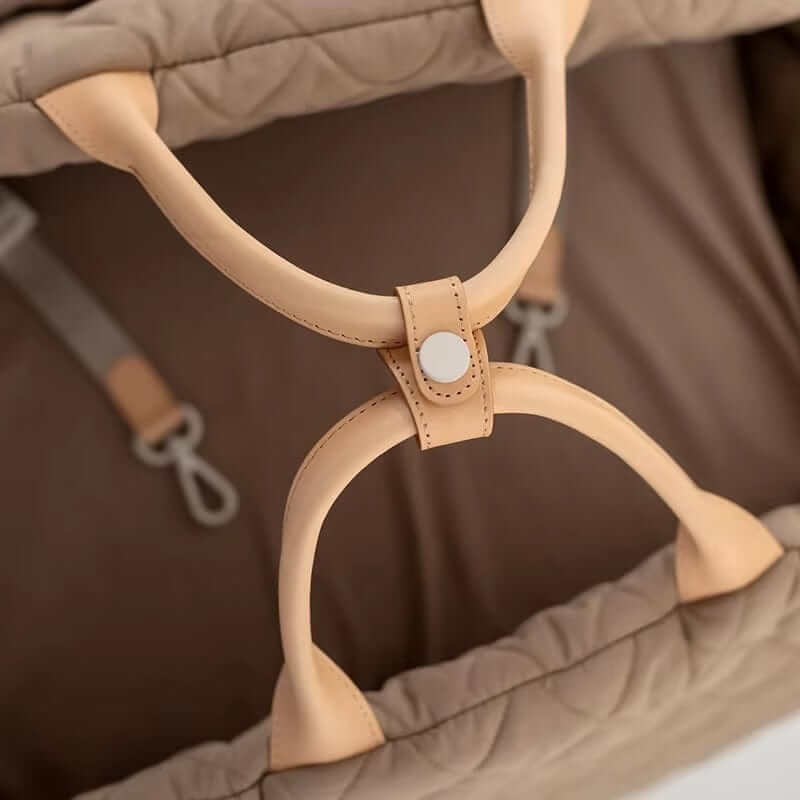 Multifunctional Pet Travel Bag close-up of durable handles, designed for dogs & cats, emphasizing comfort and safety.