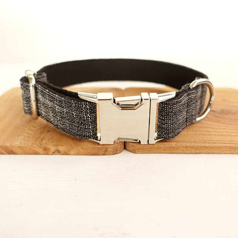 The Black Suit Dog Collar & Leash featuring a stylish black fabric collar with a silver buckle for dogs and cats.