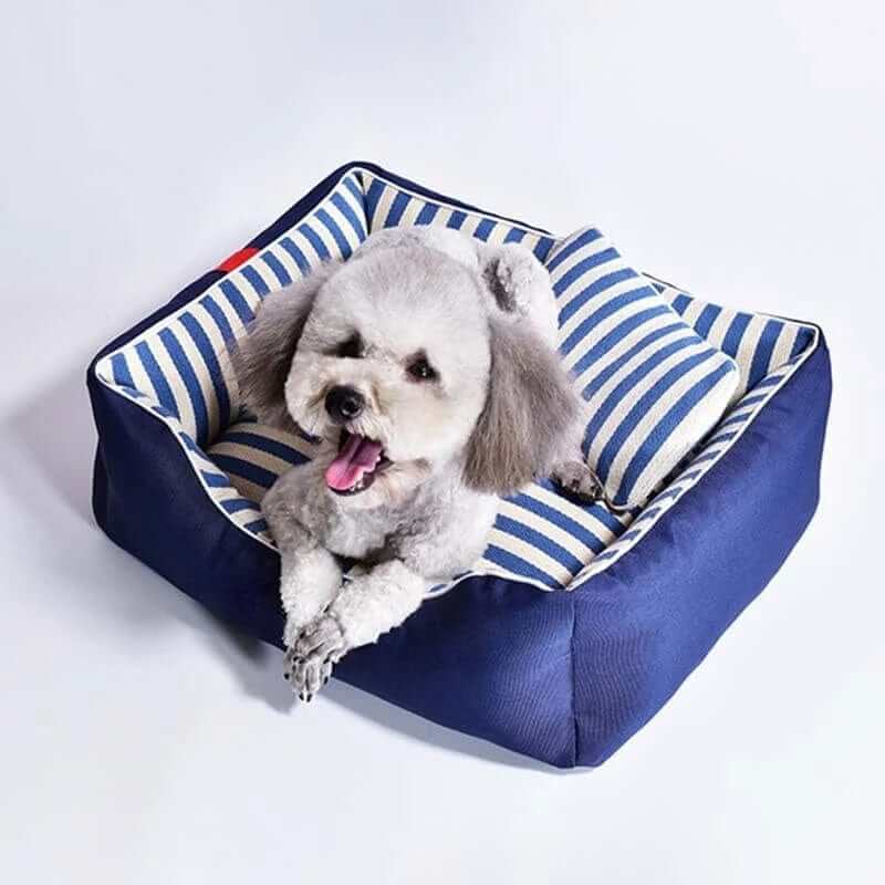 The Royal Haven Pet Bed in navy and striped design, providing cozy comfort for dogs and cats.