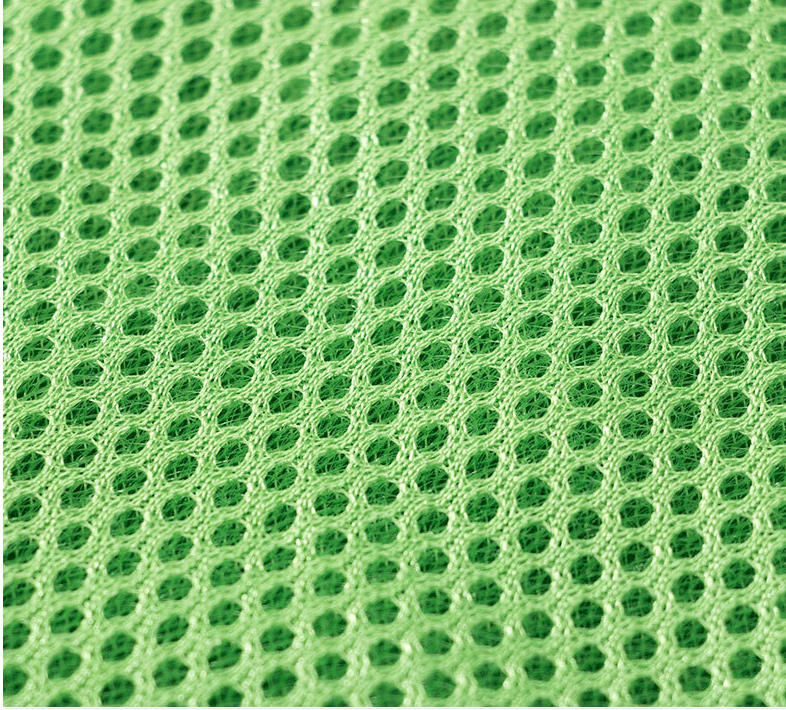 Close-up of the breathable mesh fabric featured in the Green Dino Puppy Harness Set by Dogs & Cats.