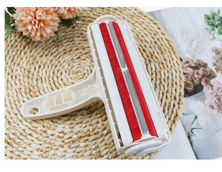 Roller Pet Hair Remover Cleaning Brush with red strips, designed for removing pet hair from fabrics and furniture.
