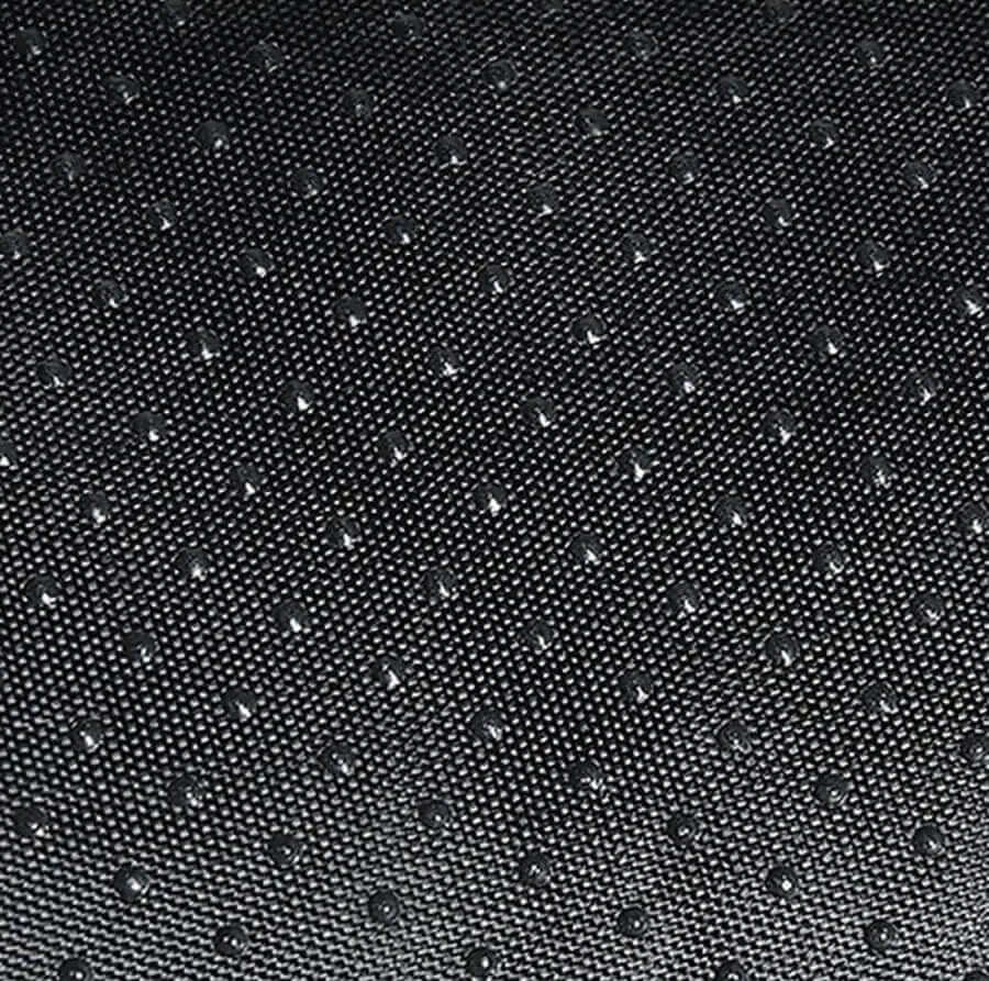Close-up of textured black fabric with raised dots, ideal for upholstery or crafting.