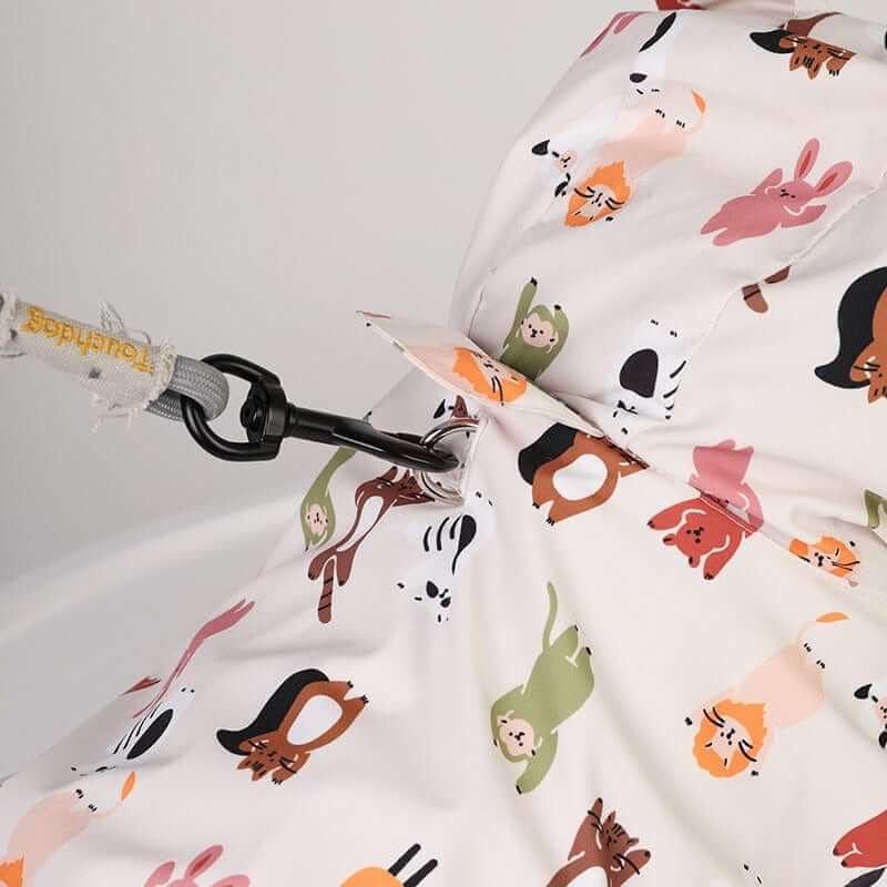 RainShield Dog Jacket with fun animal print design, lightweight waterproof fabric, perfect for dogs and cats.
