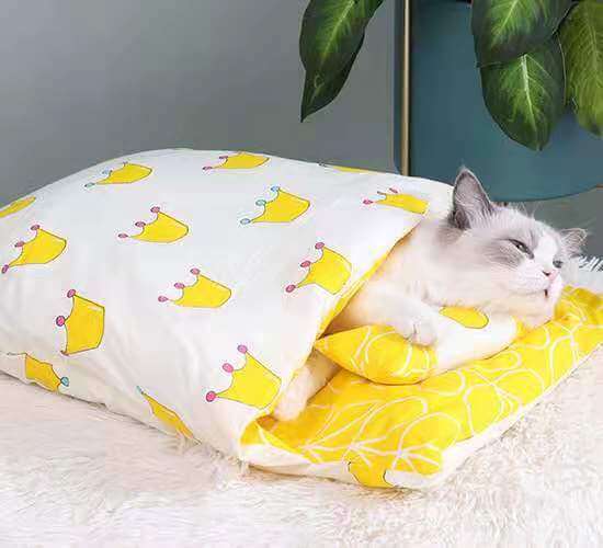 CozyNest Washable Cat Bed with cat sleeping comfortably in a colorful crown-patterned soft bed, designed for dogs & cats.