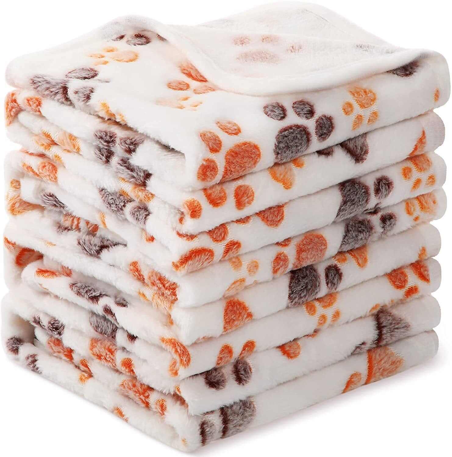 Fluffy Pet Blanket stack of soft, fluffy blankets with cartoon paw prints for dogs & cats comfort.