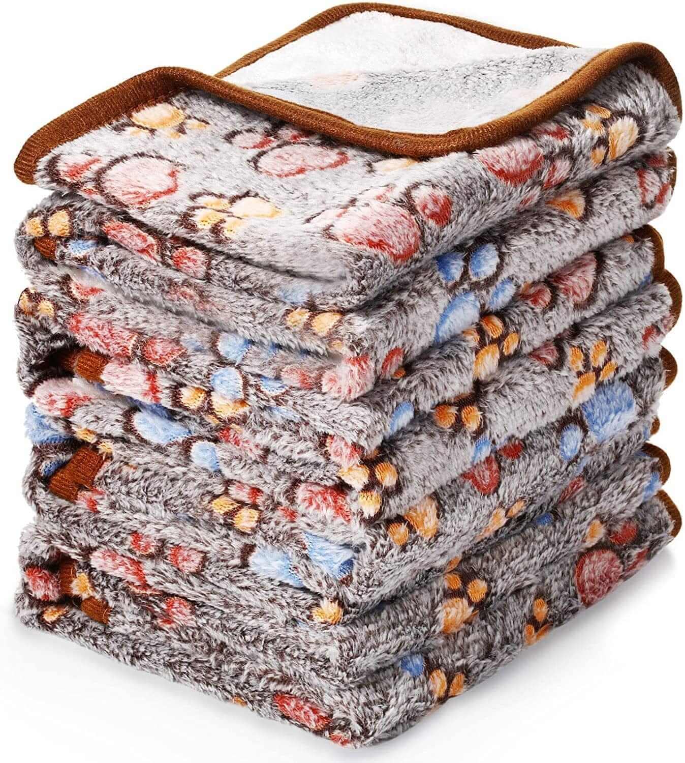 Fluffy Pet Blanket stacked, soft materials with cartoon patterns, perfect for dogs & cats.