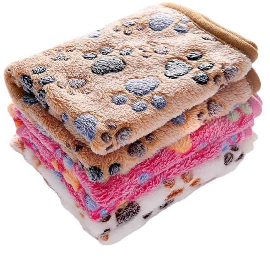 Fluffy Pet Blanket stacked, showcasing soft and fluffy materials with cute cartoon paw prints for dogs and cats.