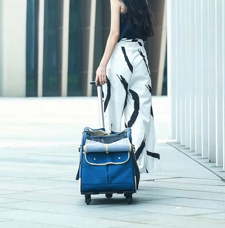 A woman pulling the RollMate Pet Carrier, a stylish pet travel bag designed for dogs and cats with a detachable trolley system.