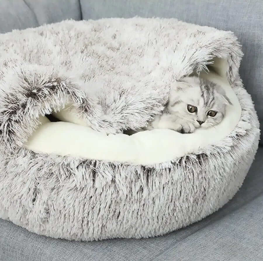 SnuggleNest Plush Cave Cat Bed with cozy plush cover for cats and dogs, providing warmth and comfort for snuggling.