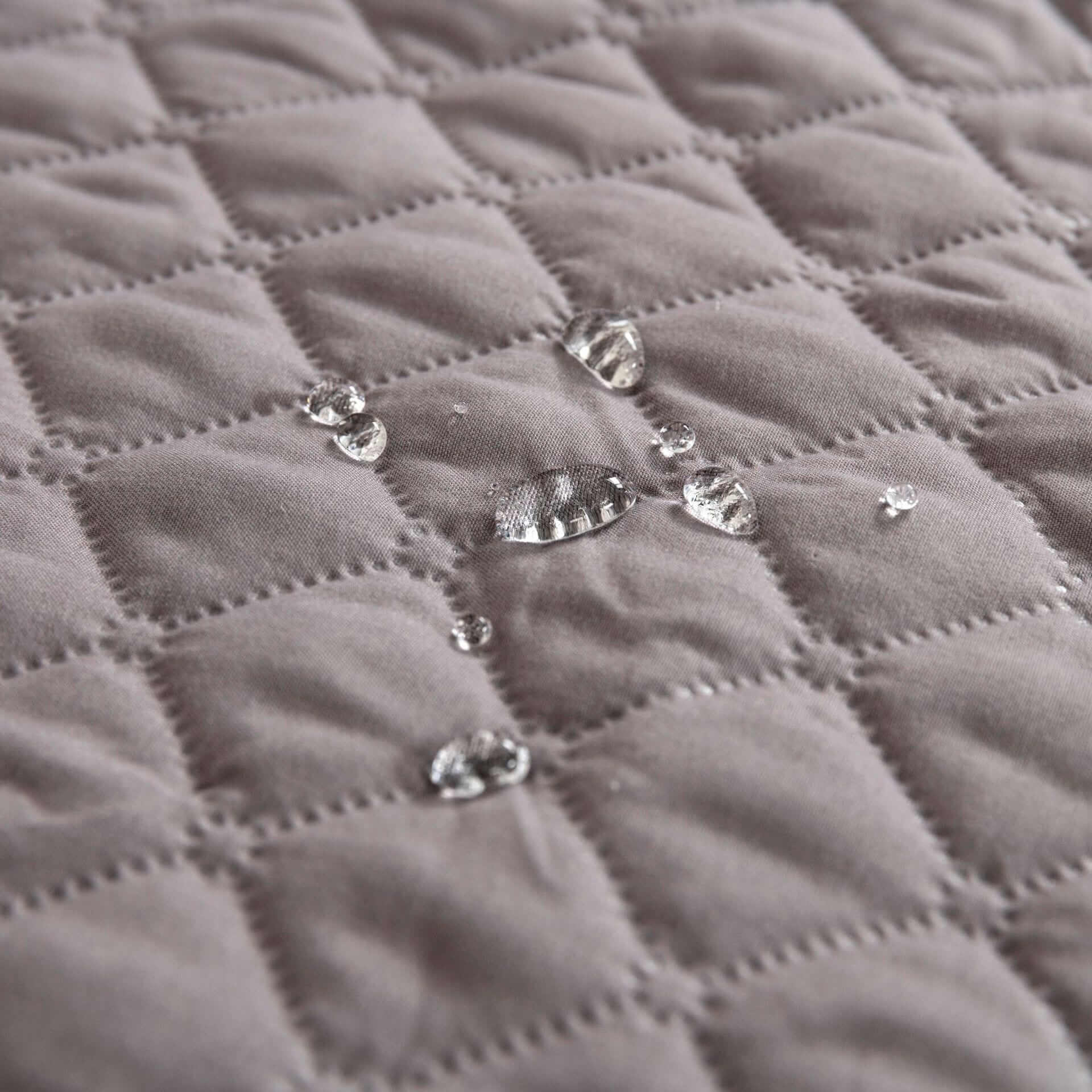 Waterproof Pet Bed Mat close-up showing water droplets on the surface, highlighting its waterproof features for dogs & cats.